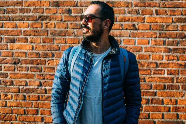 istock Cheerful laughing young man near the brick wall 1086580306