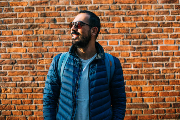 istock Cheerful laughing young man near the brick wall 1086580308