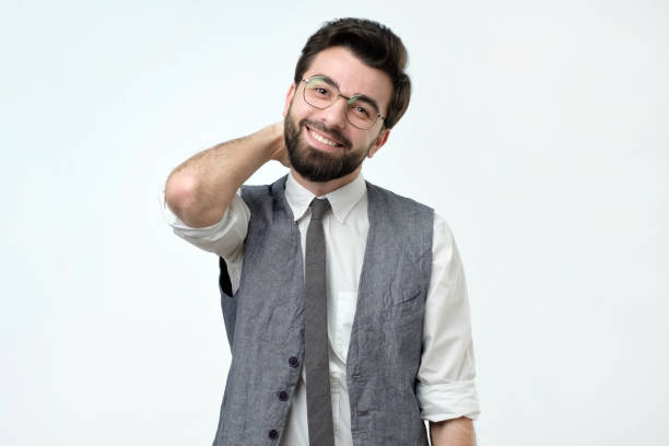 istock Hispanic man with bristle holding hand on back of head and smiling. 1086587664