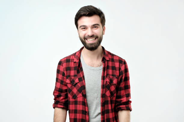 istock Young handsome man laughing and looking at camera with a big grin. 1086591754