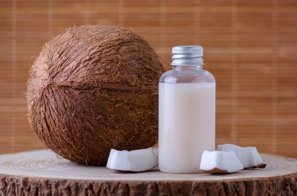 istock diy cosmetic bottle and fresh organic coconut , natural background 1086594586