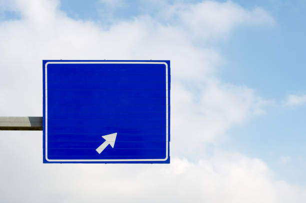 istock Blue road sign with an arrow sign 1086597032