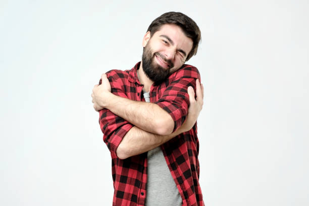 istock portrait confident smiling man hugging himself. I am the best concept. 1086598420