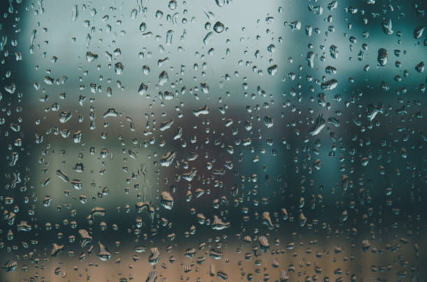 istock Background and wallpaper by rainy drop and water drops on window glass. 1086600504