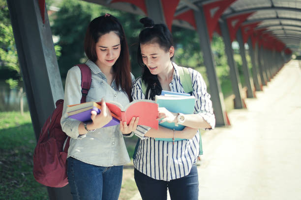 istock Education concept - Asian young women are standing read book. 1086602728