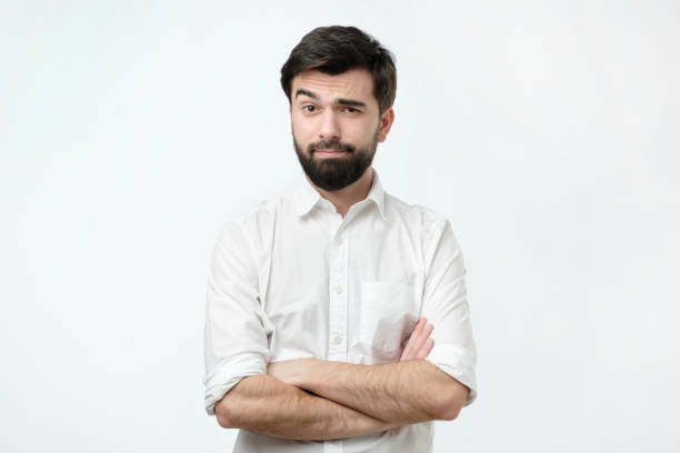 Person lifts his eyebrow and do not really believe in the words he hears, looking gloomy. Portrait of a mature man with a beard looking suspicious. Person lifts his eyebrow and do not really believe in the words he hears, looking a little bit gloomy. irony stock pictures, royalty-free photos & images