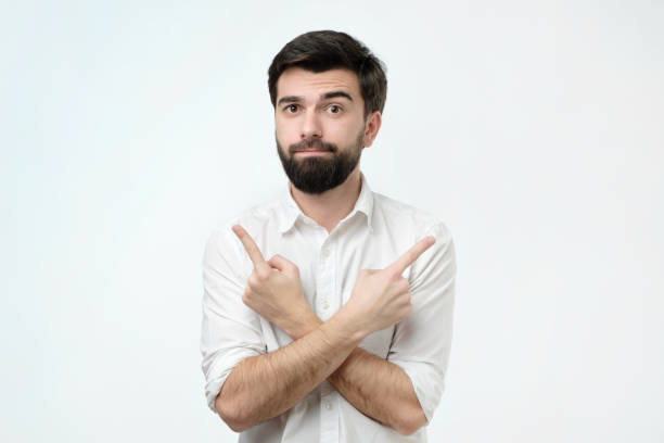 istock Hispanic man choosing between two options concept. He points to different sides by his fingers. 1086604662