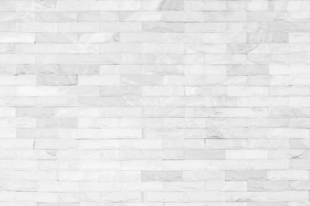 istock White brick wall art concrete or stone texture background in wallpaper limestone abstract paint to flooring and homework/Brickwork or stonework clean grid uneven interior rock old. 1086604808