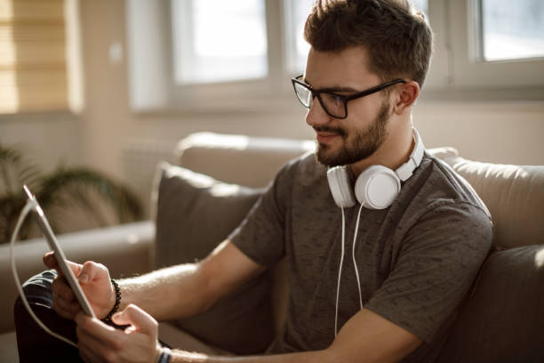 istock Young man using social media at home 1086607076