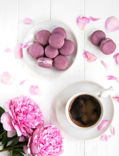 istock Pink peony with coffee and macarons 1086609914