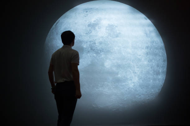 istock Mature Man Looking At Full Moon In Sky At Night 1086610770