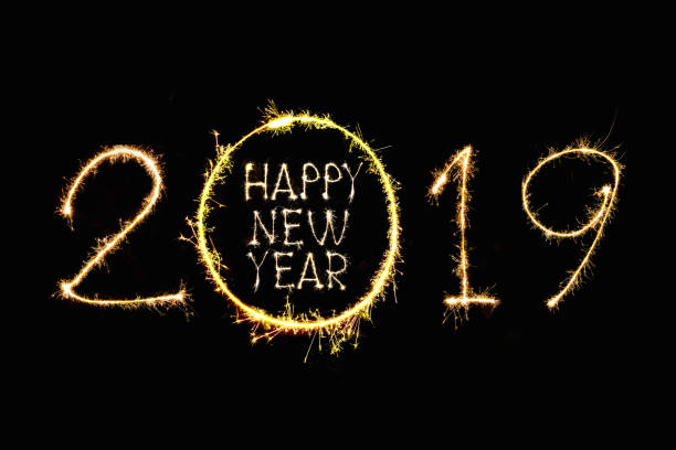 istock Happy New Year 2019 text hand written sparkles fireworks 1086612328