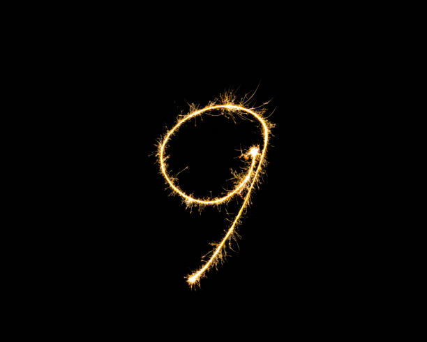 istock Numbers 9 or nine Sparkler firework light isolated on black background 1086612376