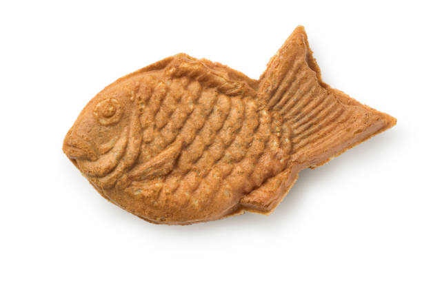 Single fresh baked Taiyaki, Japanese fish shaped cake filled with red bean pasteisolated on white background