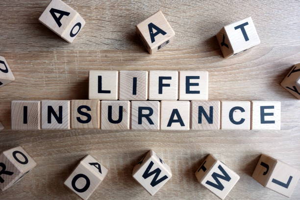 Life insurance text from wooden blocks Life insurance text from wooden blocks on desk life insurance stock pictures, royalty-free photos & images