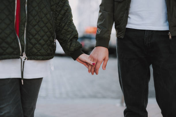 istock Beautiful loving couple holding hands on blurred background 1086628438