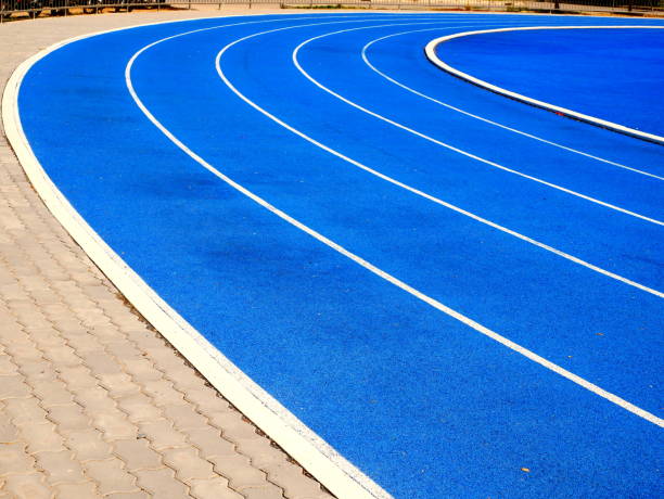 istock Running track Lanes of blue running track 1086633584