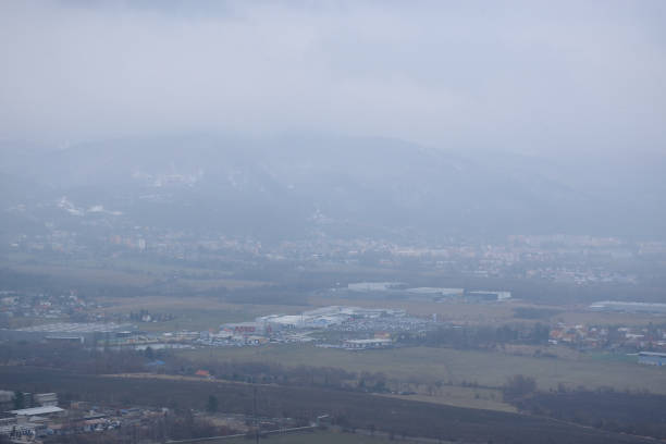 istock Teplice, Czech republic - December 15, 2018: industrial zone under Krusne hory mountains viewed from Doubravka castleduring snowfall in winter 1086636114