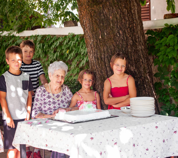 Grandchildren and Grandmother at Birthday Celebration Grandchildren and Grandmother at Birthday Celebration. 90 plus years photos stock pictures, royalty-free photos & images