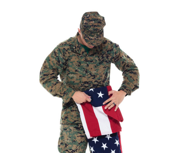 istock US Marine in uniform holding the US flag 1086643352