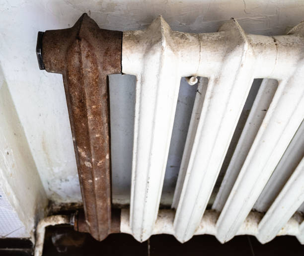 istock view of shabby heating radiator with rusty section 1086645524
