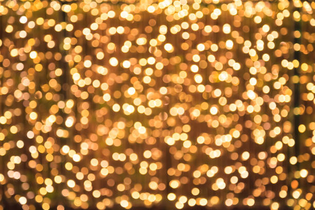 istock Glittering Glowing and Sparkling defocused Blinking Warm Gold Light (bokeh) Illumination outdoor wall decoration background. Special Holidays, Festival design decoration, New Year Celebration, Party. 1086645910