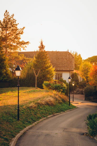 istock Small alley under sunset light with street lights 1086647156