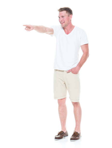 istock Handsome man in shirt and shorts is pointing forward 1086649220
