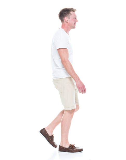 istock Handsome man in shirt and shorts is walking, side view 1086649224