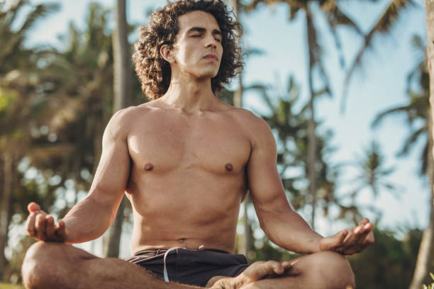 istock Shirtless man doing meditation exercises 1086649234