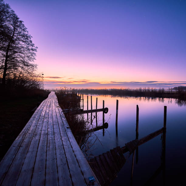 istock bridge leading along a river at sunrise a winter morning 1086652234