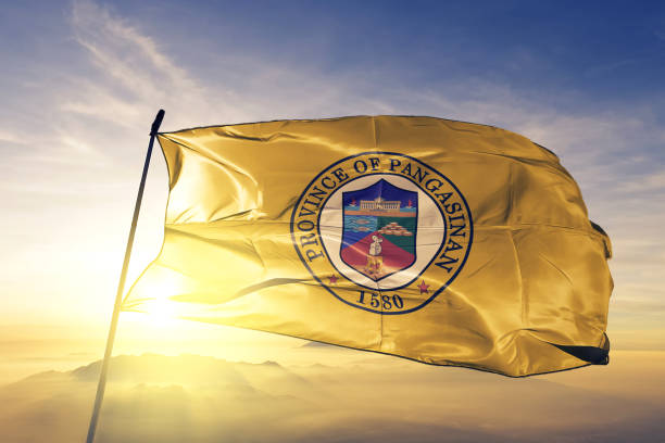 Pangasinan province of Philippines flag textile cloth fabric waving on the top sunrise mist fog Pangasinan province of Philippines flag on flagpole textile cloth fabric waving on the top sunrise mist fog pangasinan stock pictures, royalty-free photos & images