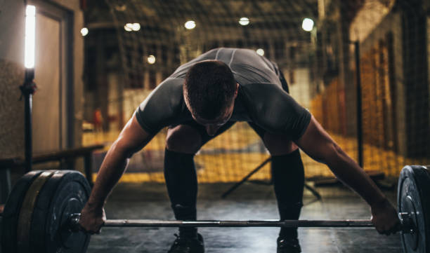 istock Muscular man deadlifting barbell in gym 1086661726