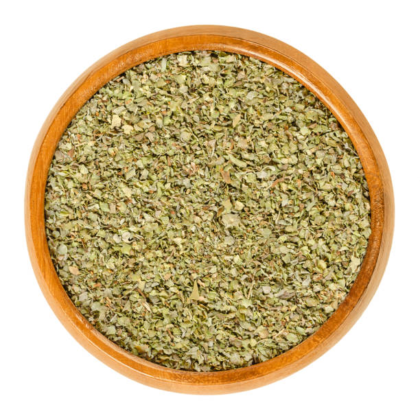 istock Dried marjoram in wooden bowl over white 1086663338