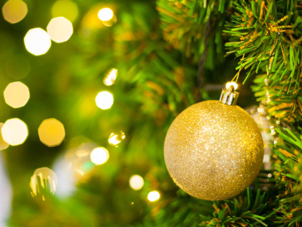 istock Glittering Baubles with Glowing Sparkling Gold defocused Light (bokeh) Illumination background with decorated Christmas Tree. Special Holidays, Festival design decoration, New Year Celebration, Party. 1086663632