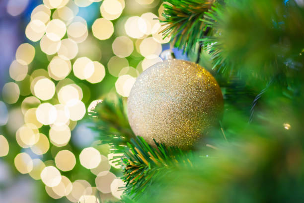 istock Glittering Baubles with Glowing Sparkling Gold defocused Light (bokeh) Illumination background with decorated Christmas Tree. Special Holidays, Festival design decoration, New Year Celebration, Party. 1086663702