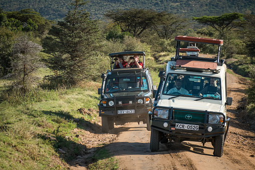 Masai Mara, KENYA - September 6, 2018. Some tourist jeeps in the savannah looking for animals