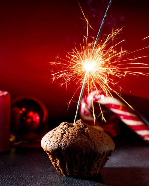 istock chocolate muffin with burning sparkler 1086671168