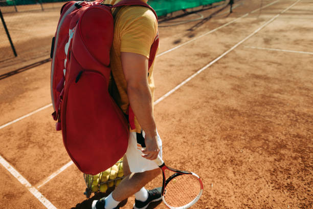 Young tennis player standing on tennis court