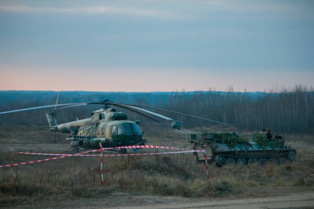 istock A tank hidden behind pine trees and helicopter in polygon 1086678304