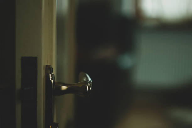 istock An opening door to a darker room 1086678312