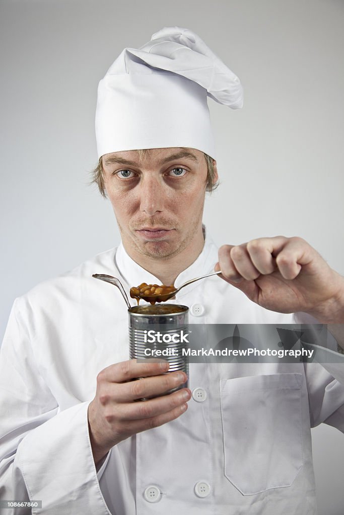 Disappointed Chef with Tinned Food A disappointed chef has to eat tinned food Adult Stock Photo