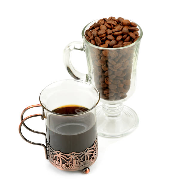istock Hot coffee in a delicate glass and coffee beans isolated on white 1086689856