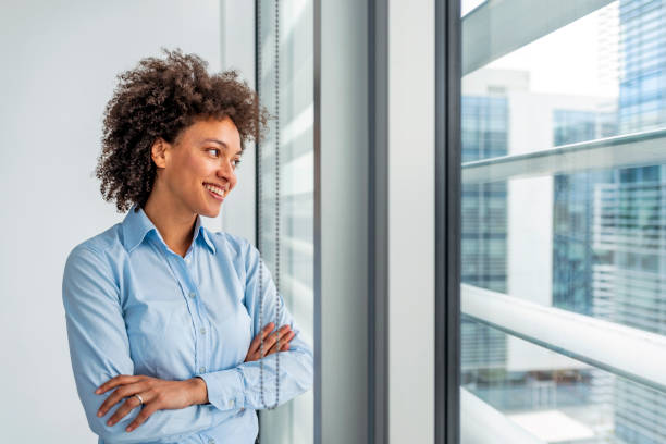 istock Confident female manager leaning on window 1086691196