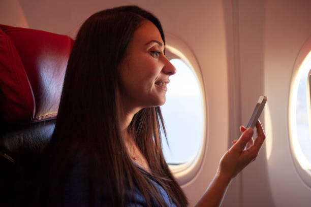 istock Woman using a smart phone on airplane 1086693172