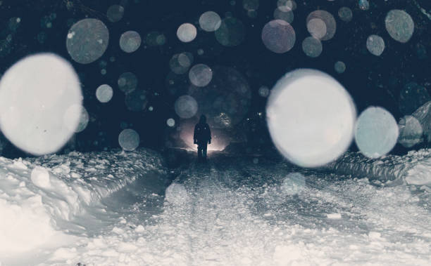 istock One man on a mysterious snowy night street 1086699554