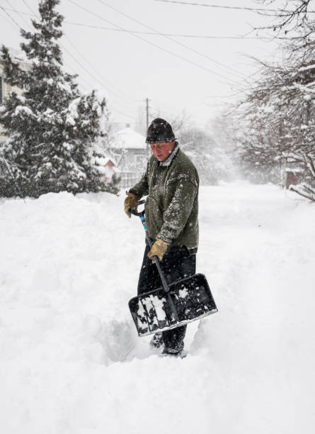 istock Man with a shovel cleans the track from the snow 1086699570
