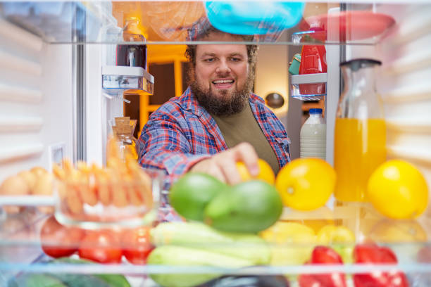 istock Man looking for something to eat at night. 1086701230