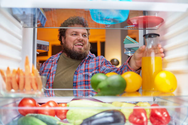 istock Man looking for something to eat at night. 1086701260