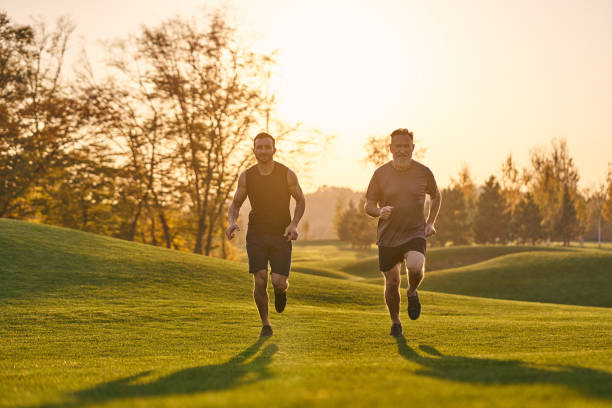 istock The father and son running in the beautiful park 1086701342